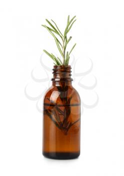 Bottle with rosemary essential oil on white background�