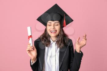 Happy female graduating student with diploma on color background�