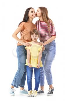 Happy lesbian couple with little adopted girl on white background�