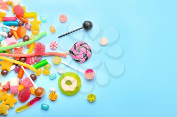 Assortment of sweet candies on color background�