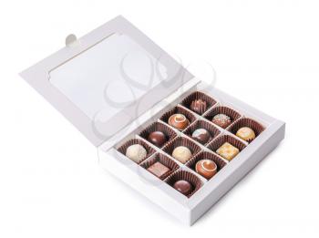Box with delicious chocolate candies on white background�
