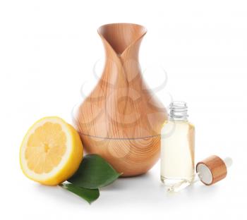 Aroma oil diffuser and lemon on white background�