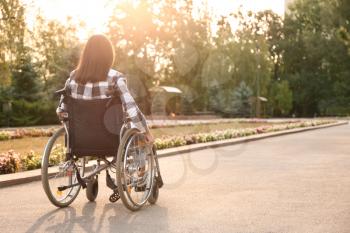 Young woman in wheelchair outdoors�