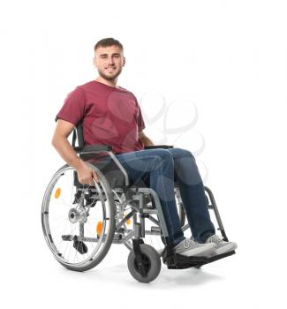 Happy young man in wheelchair on white background�