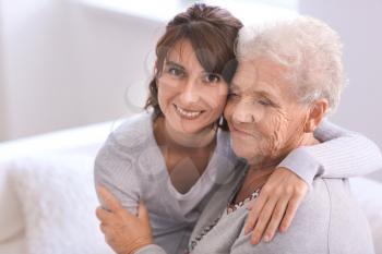 Happy elderly woman with her daughter at home�