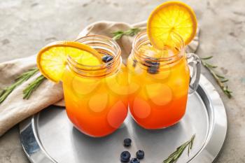 Mason jars with delicious summer cocktails on table�