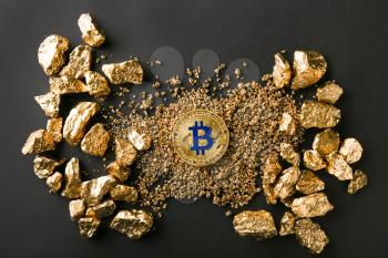 Bitcoin and gold nuggets on black background�