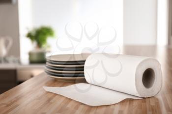 Roll of paper towels with plates on kitchen table�