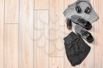 Composition with sportswear on wooden background�