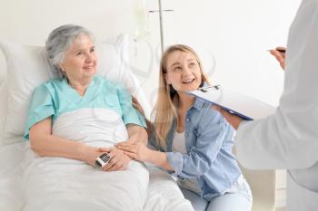 Young woman visiting her grandmother in hospital�