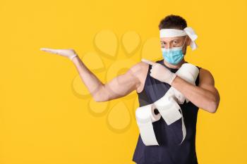 Funny man with toilet paper showing something on color background. Concept of coronavirus epidemic�