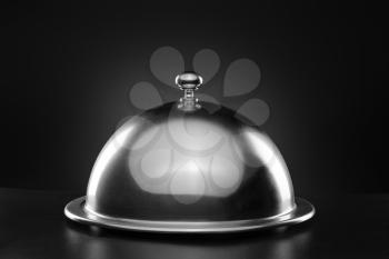 Tray and cloche on dark background�