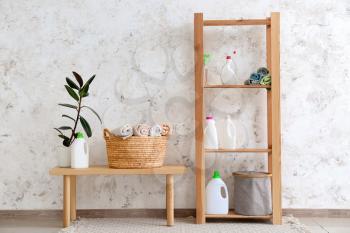 Baskets with clean towels and detergents in laundry room�