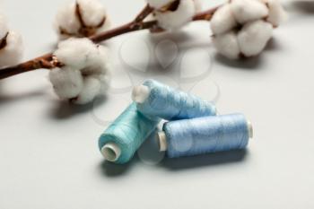 Cotton flowers and threads on light background�