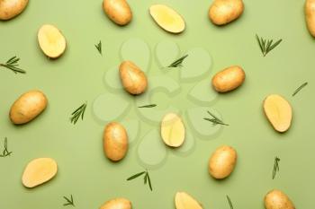 Raw potatoes on color background�