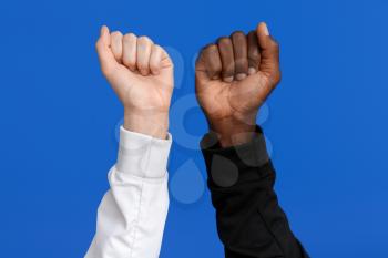Caucasian woman and African-American man with clenched fists on color background. Racism concept�