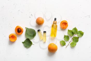 Bottles of apricot essential oil on white background�