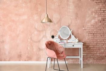 Table with mirror and makeup cosmetics in modern dressing room�