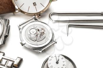 Watches and tools for repair on white background�
