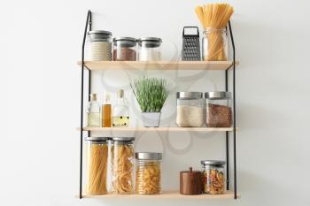 Set of jars with products on kitchen shelves�