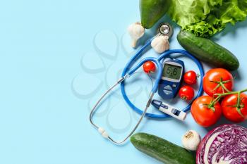 Vegetables, stethoscope, lancet pen and glucometer on color background. Diabetes concept�