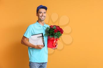 Delivery man with bouquet of flowers on color background�