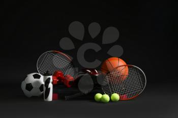 Set of sports equipment on dark background�