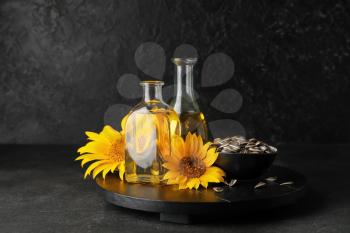Composition with sunflower oil on dark background�