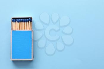 Box with matches on color background�