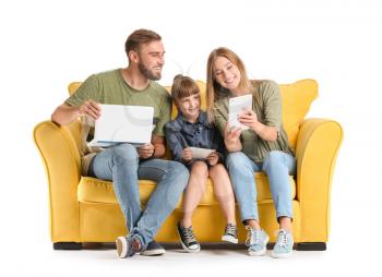 Happy family with gadgets on sofa against white background�