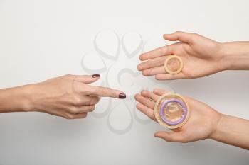 Female hands with different contraceptives on white background�
