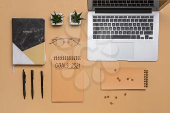 To do list on 2021 year with laptop and stationery on color background�