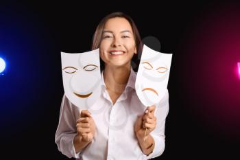 Young talented actress with different masks on dark background�