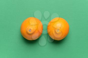 Fresh juicy oranges on color background. Erotic and female health care concept�