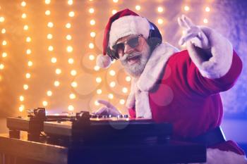 Cool Santa DJ playing music in club�