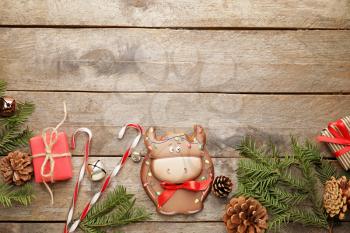 Tasty cookie in shape of bull and Christmas decor on wooden background�