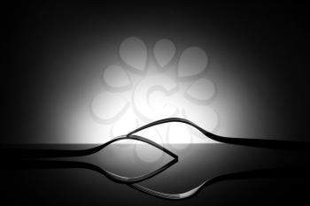 Creative composition with stylish forks on dark background�