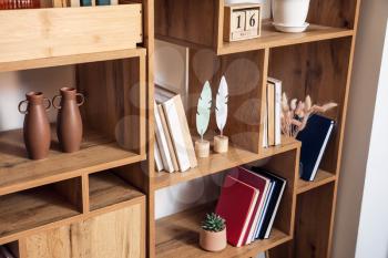Modern shelf units with books and decor, closeup 