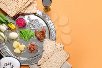 Passover Seder plate with traditional food on color background�