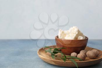 Bowl with shea butter on table�