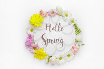 Card with text HELLO SPRING and beautiful flowers on white background�