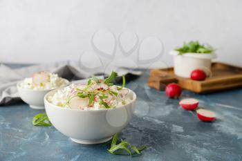Bowls with cottage cheese on color background�