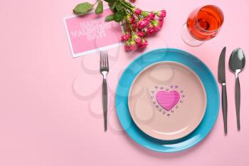Festive table setting for Valentines Day celebration on color background�