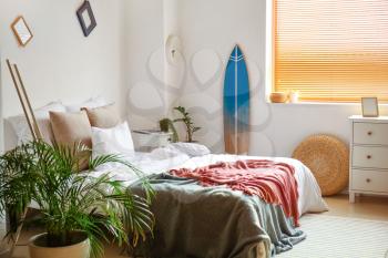 Interior of modern bedroom with surfboard�