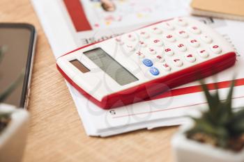 Calculator and documents on table�