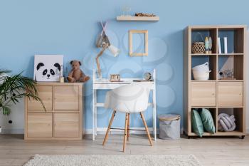 Interior of stylish children's room with modern workplace�