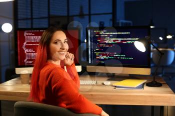 Female programmer working in office at night�