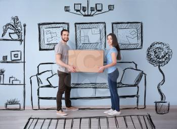 Young couple holding box indoors and imagining interior of new house. Moving day�