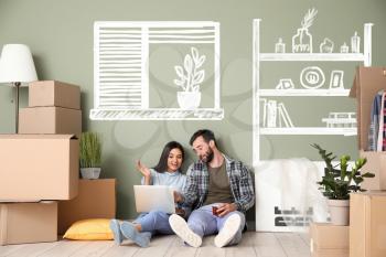 Happy couple with laptop imagining interior of new house�