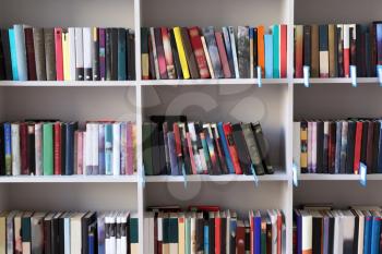 Many books on shelves in modern library�
